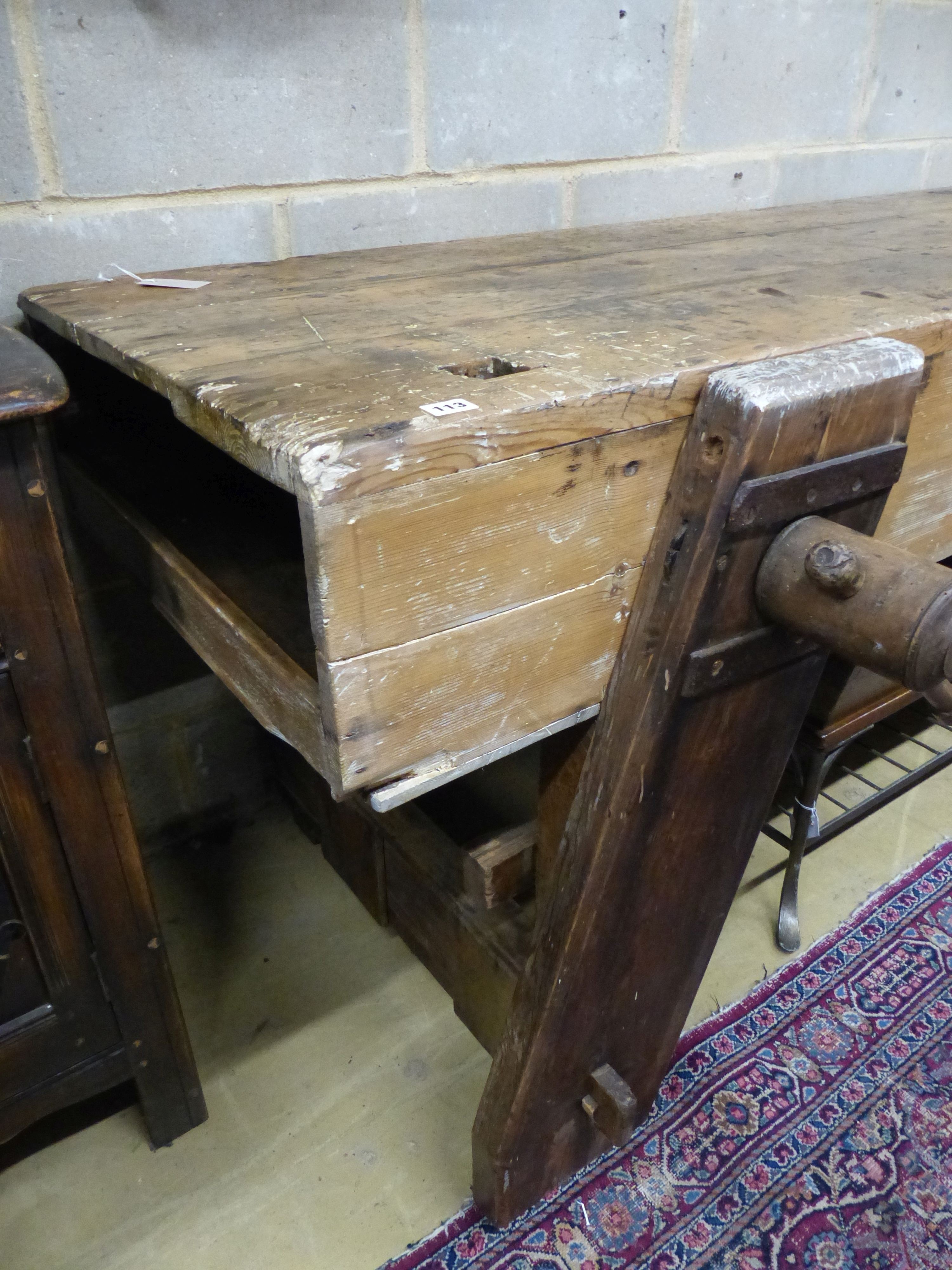 A 19th century pine workbench with original vice, W.244cm D.70cm H.83cm